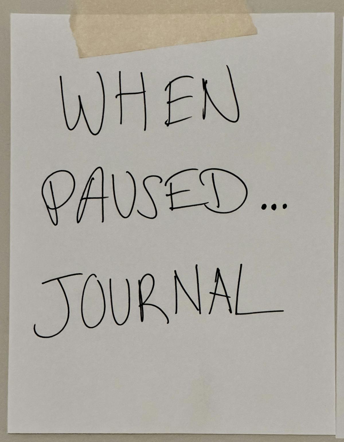 a piece of paper with the words 'when paused... journal' written on it